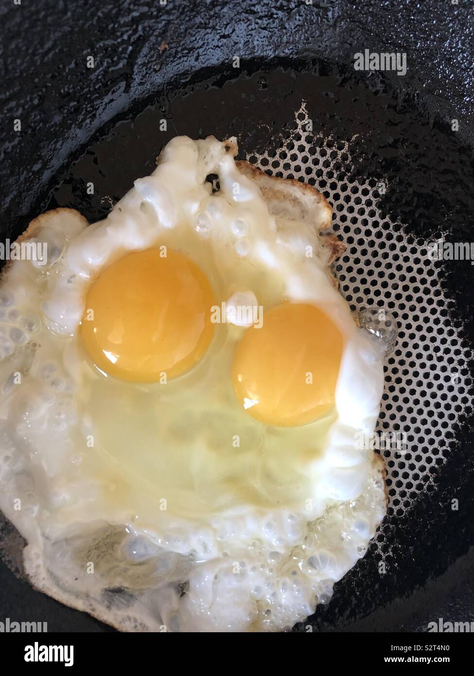 Two yolks in one egg, twins Stock Photo Alamy