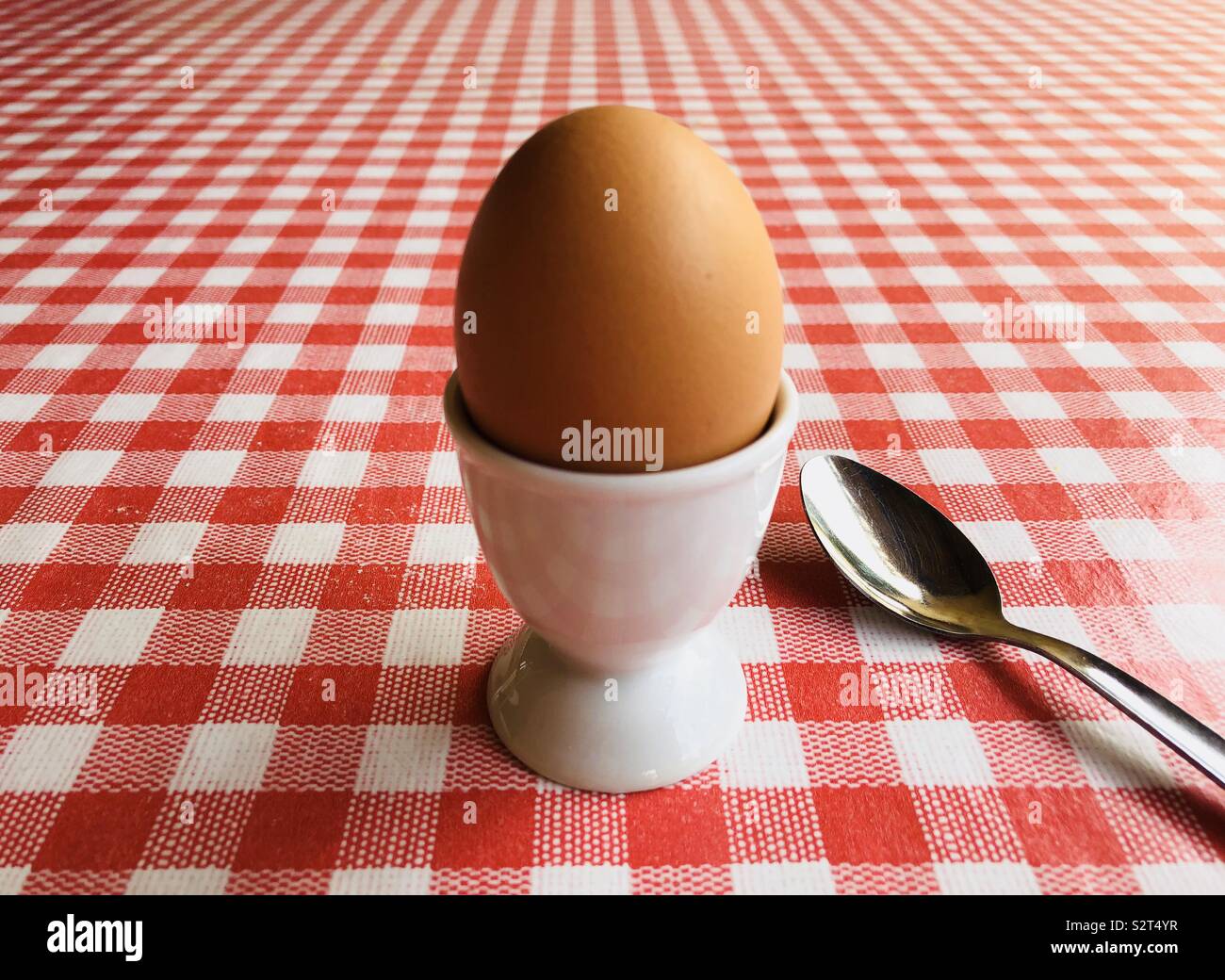 Boiled egg and teaspoon on table - Smartphone Captured Stock Image