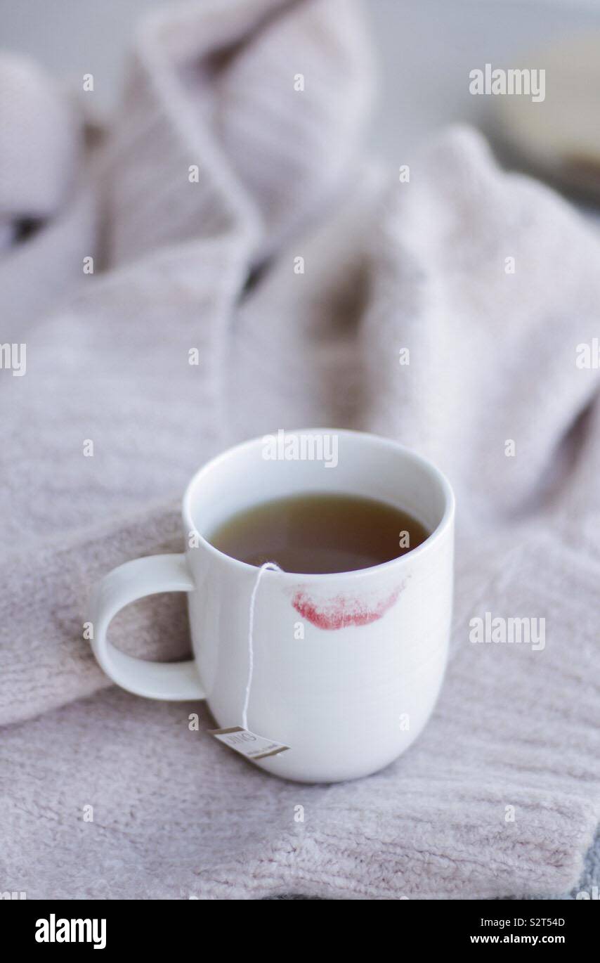 Red lipstick on mug of hot drink tea coffee Stock Photo