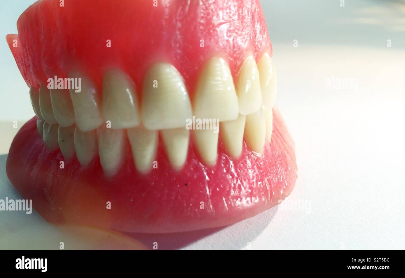 Close up of a brand new full set of dentures on white background - Smartphone Captured Stock Image