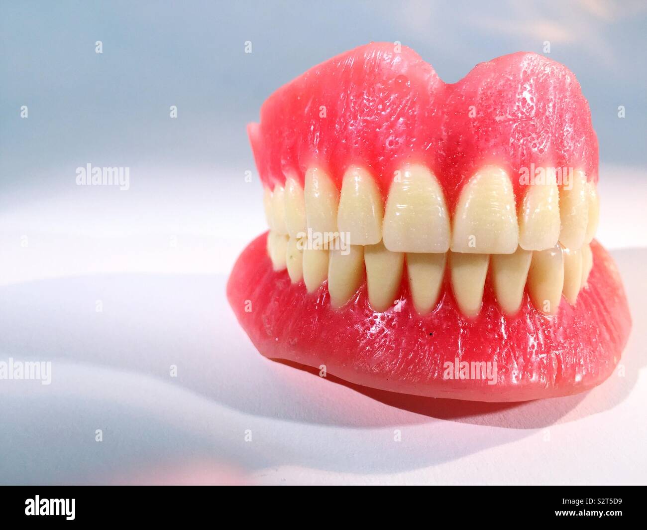 Close up of a full set of dentures on white background - Smartphone Captured Stock Image
