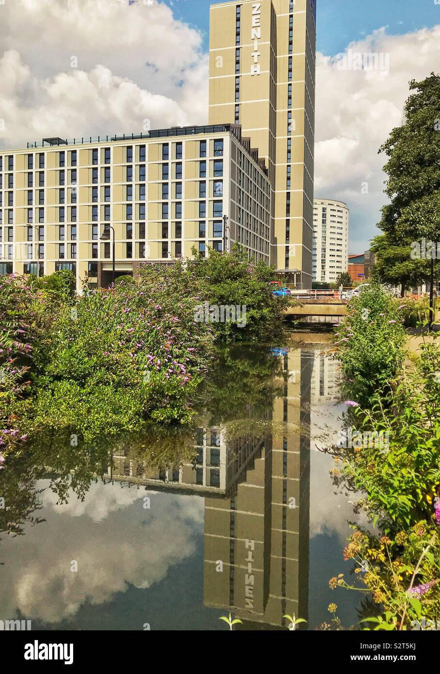 New student accommodation in Cardiff city centre with reflection in the still waters of a canal - Smartphone Captured Stock Image