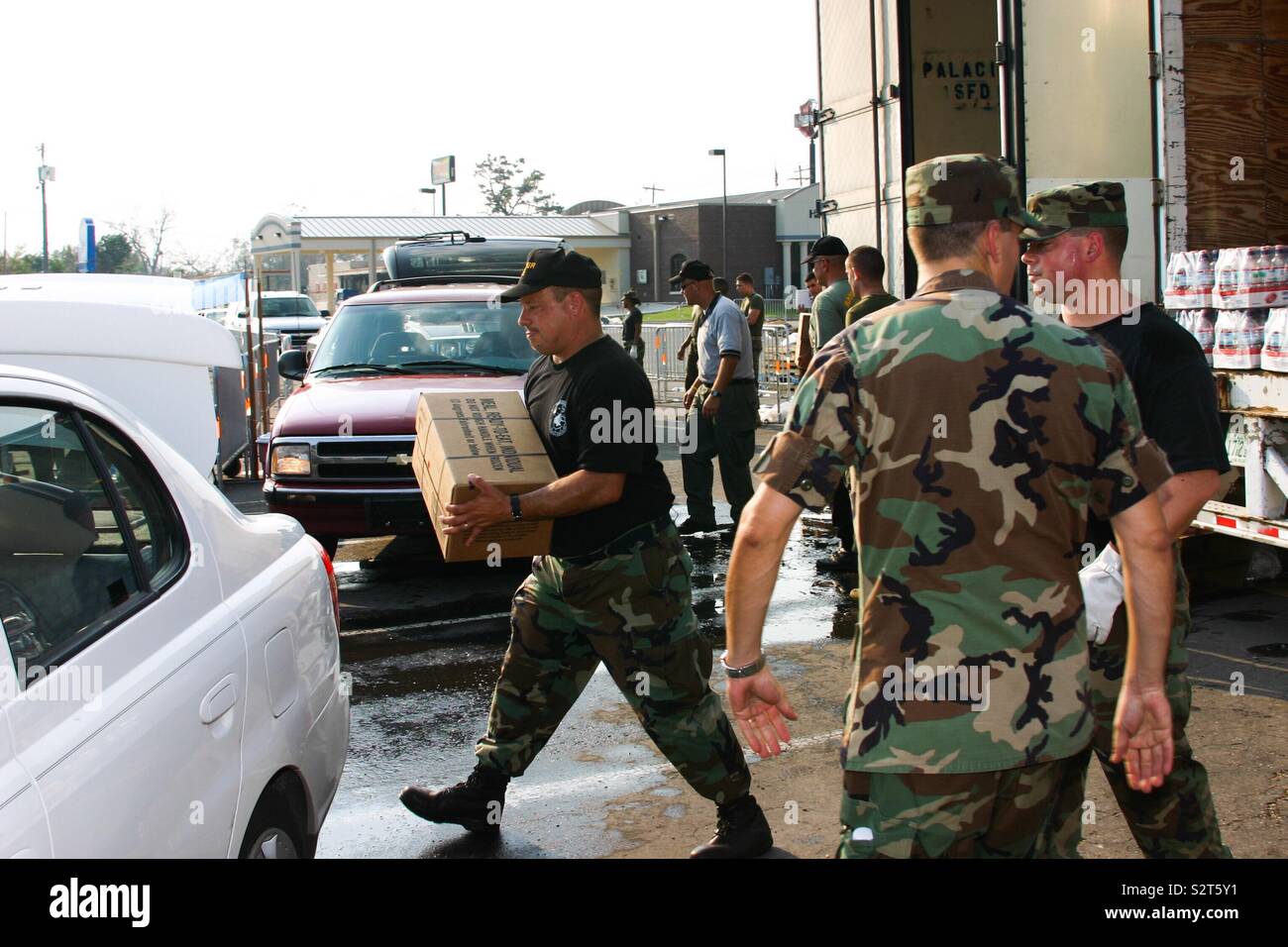 Air Force Sergeant loads emergency supplies into civilian car. Stock Photo