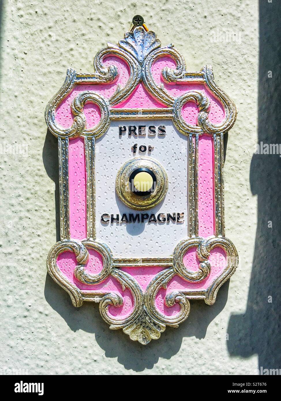 A funny doorbell in Santa Monica, California says Press For Champagne. Stock Photo