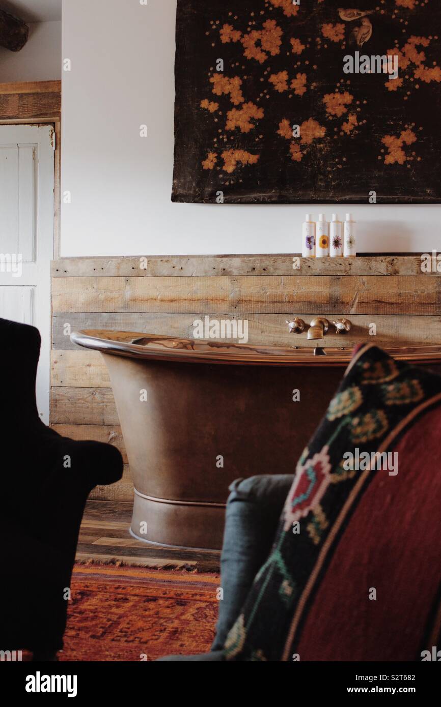 Copper bath in rustic hotel room Cotswolds Stock Photo Alamy