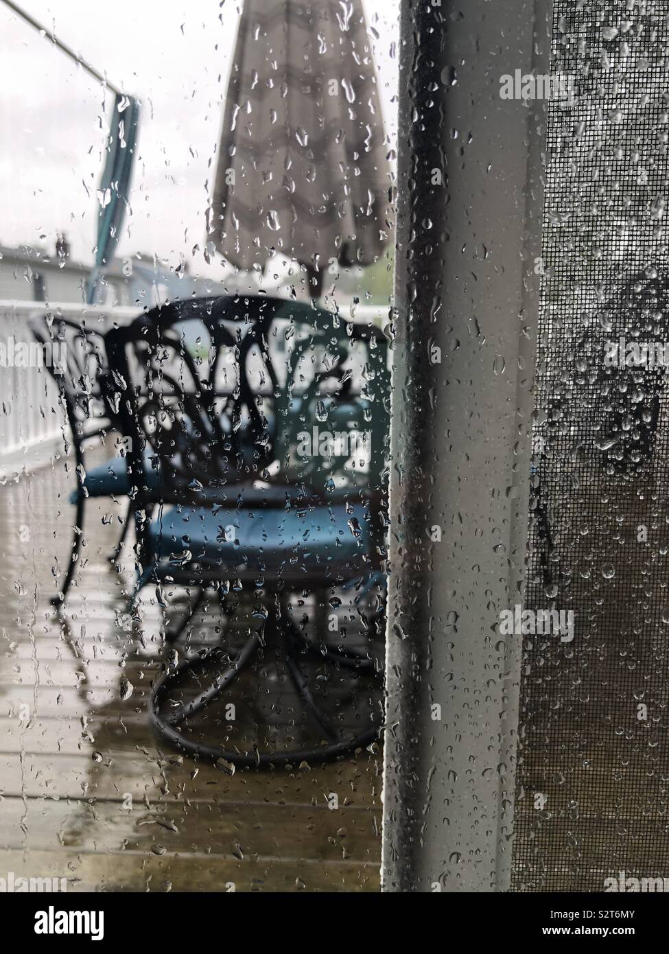 Water Drops On Patio Door With Screen During A Rain Storm Stock