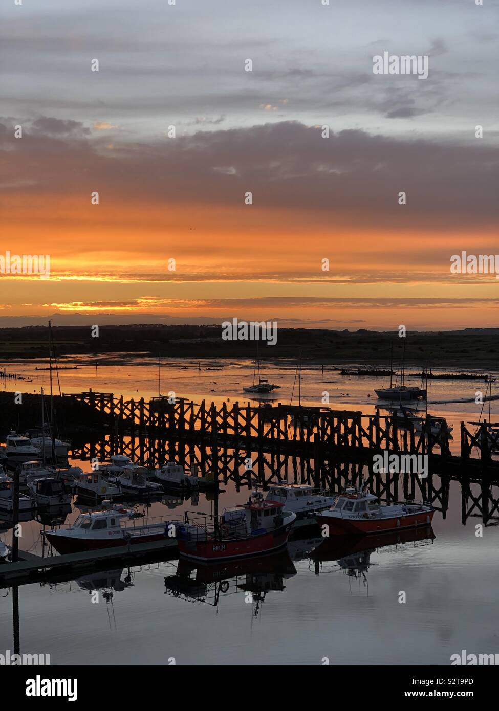 Sunset over the old, wooden jetty, Amble, Northumberland UK - Smartphone Captured Stock Image