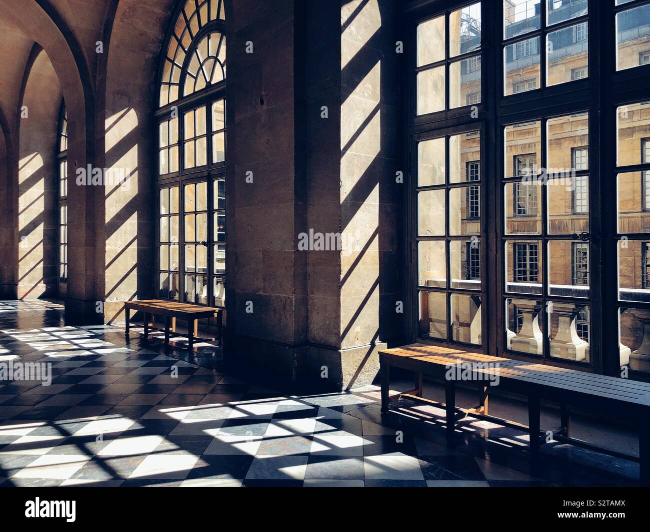 Sunlight shines through the windows and casts shadows  in Versailles Palace - Smartphone Captured Stock Image