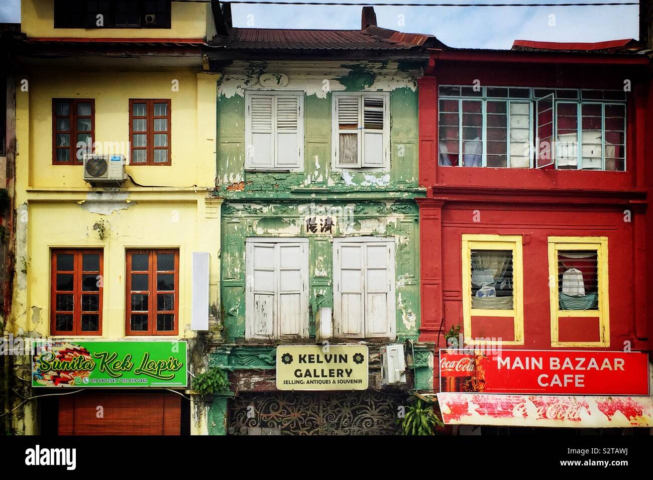 The colourful façades of terraced shophouses in the old Main Bazaar at Kuching Waterfront, Sarawak, Malaysia Stock Photo
