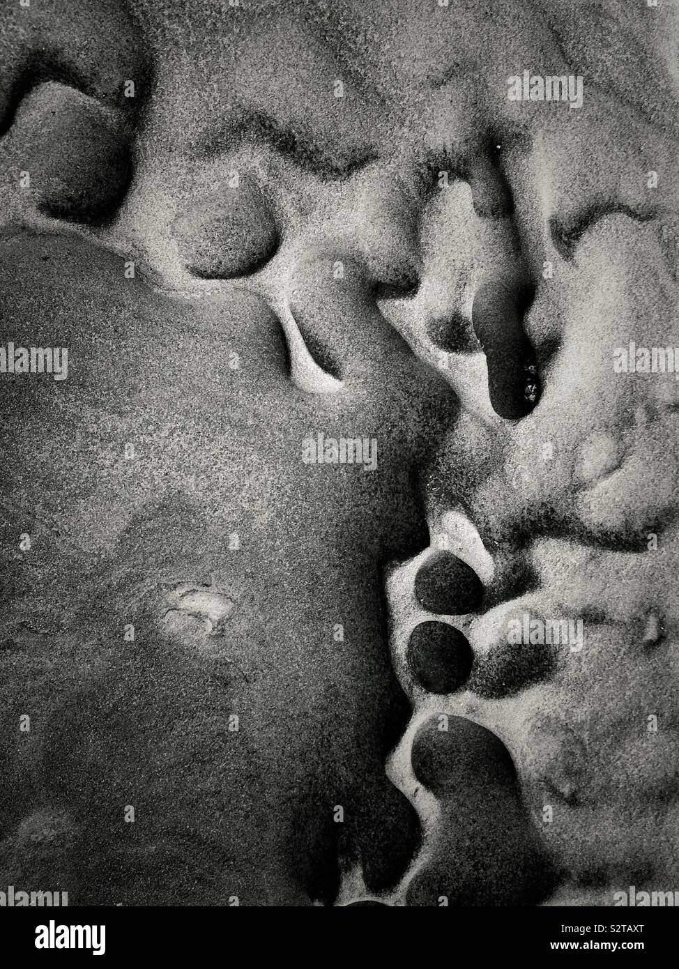 Abstract rocks on the Talacre beach on the north coast of Wales in the community of Llanasa. UK - Smartphone Captured Stock Image