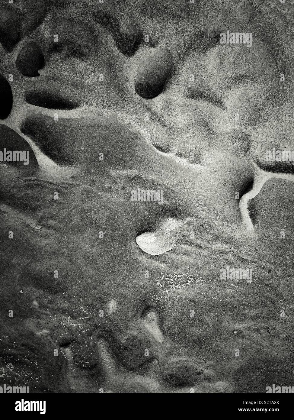 Abstract rocks on the Talacre beach on the north coast of Wales in the community of Llanasa. UK - Smartphone Captured Stock Image