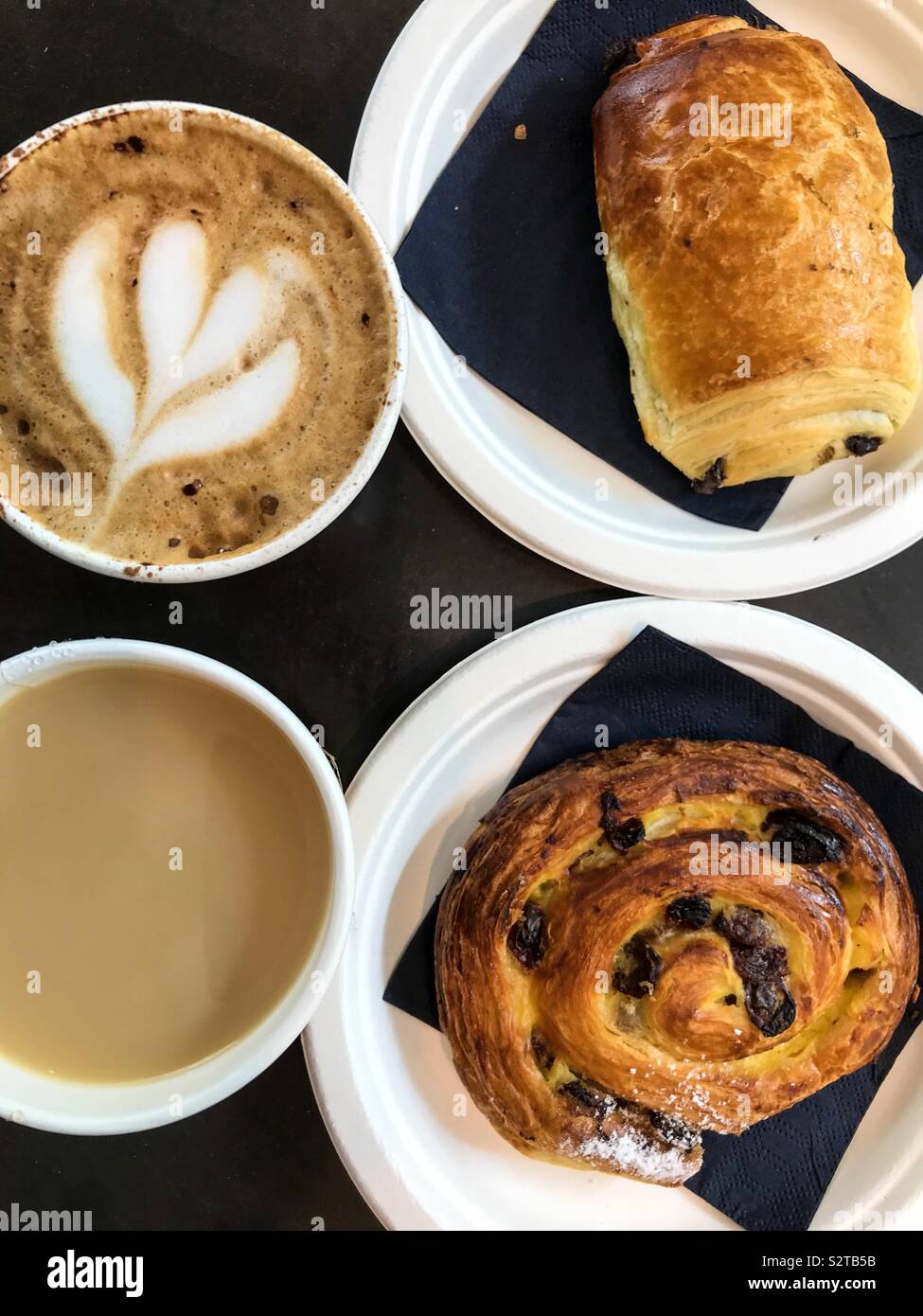 Breakfast for two people consisting of pastries, tea and coffee. - Smartphone Captured Stock Image