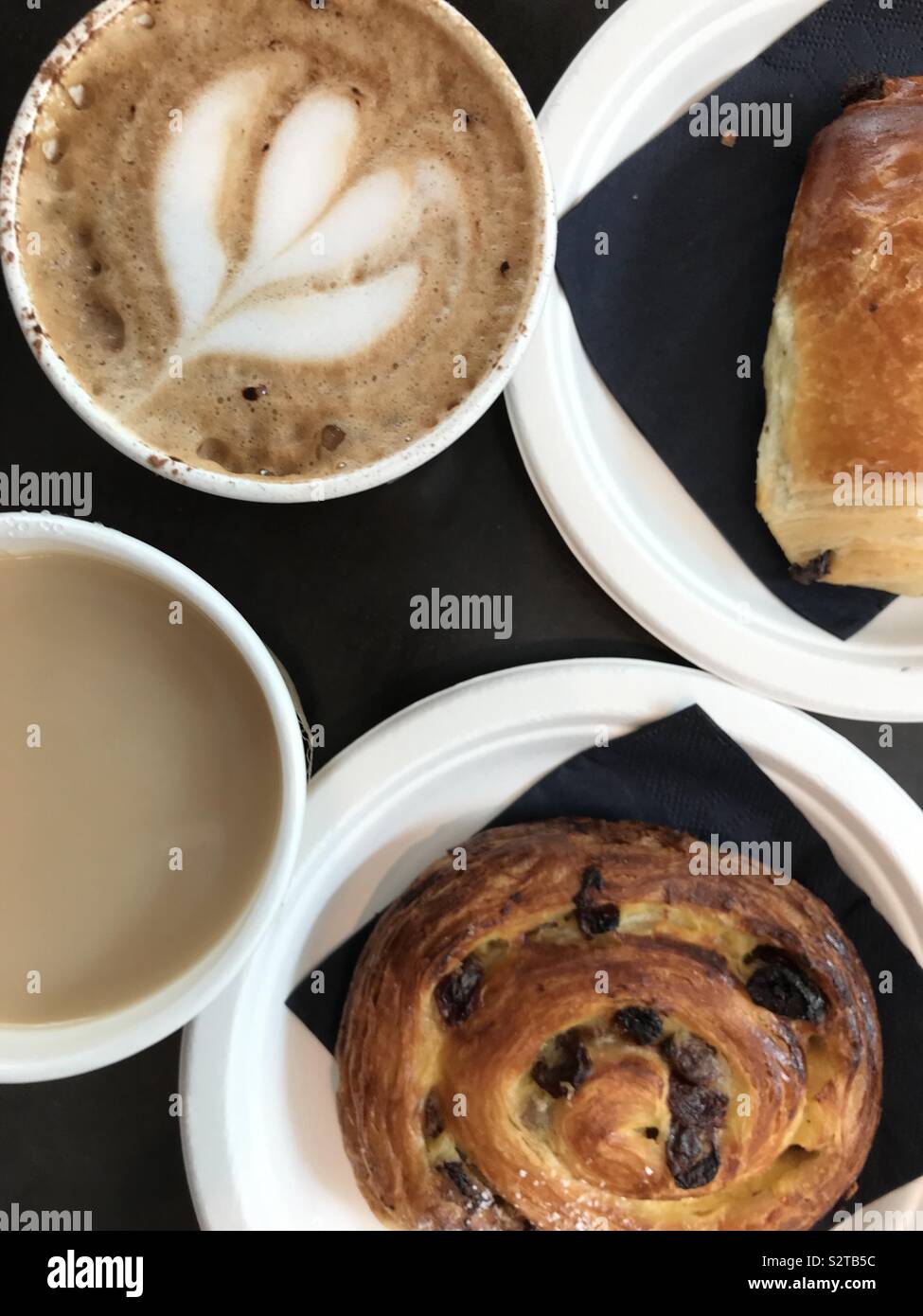 Breakfast for two people consisting of pastries, tea and coffee. - Smartphone Captured Stock Image