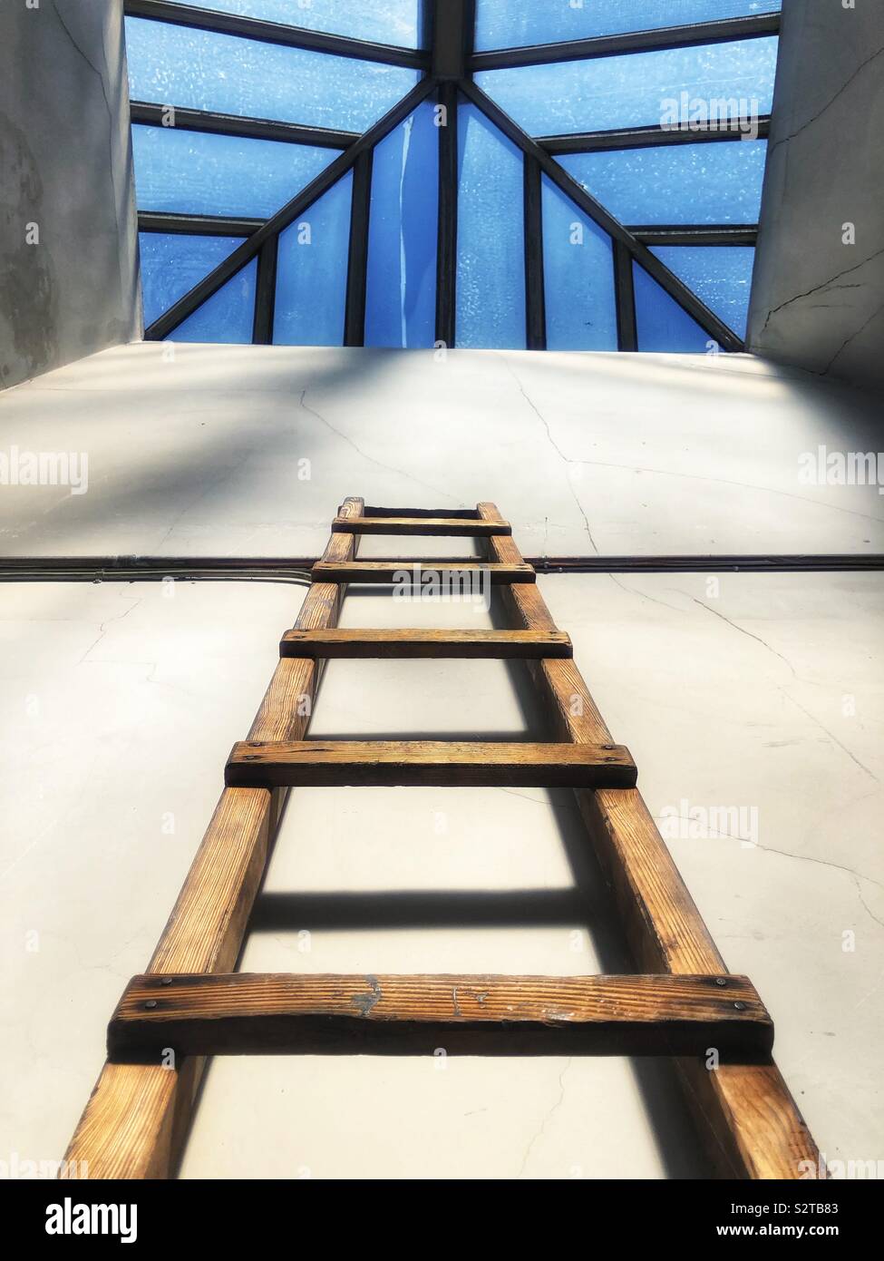 Looking up at wooden ladder and skylight - Smartphone Captured Stock Image
