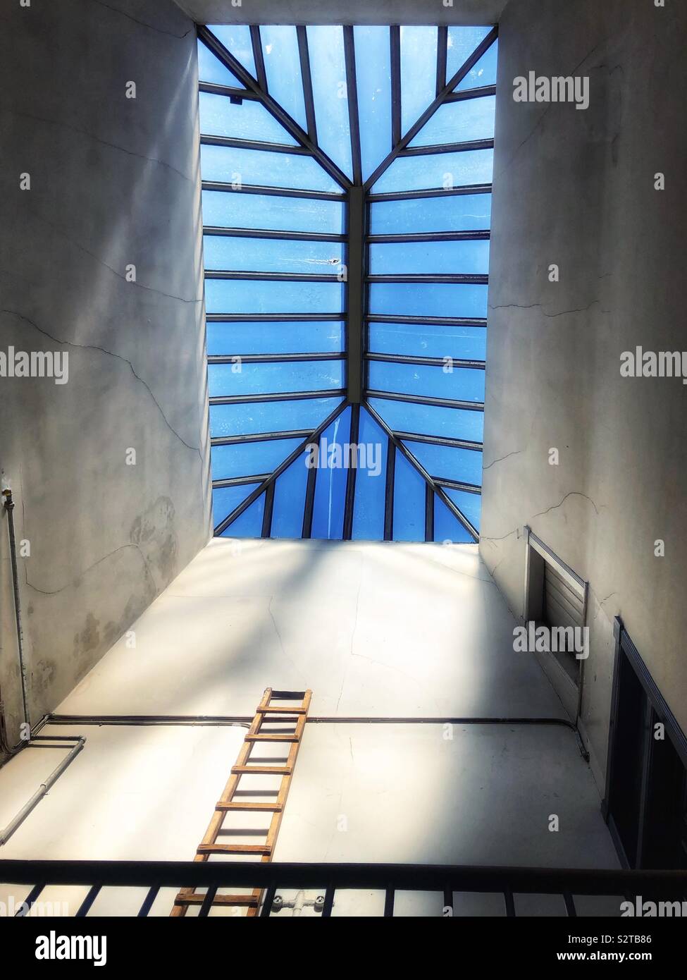 Looking up at wooden ladder and skylight - Smartphone Captured Stock Image