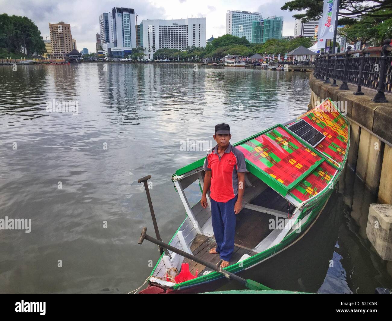 A boatman and his traditional Malay sampan, modernised with solar