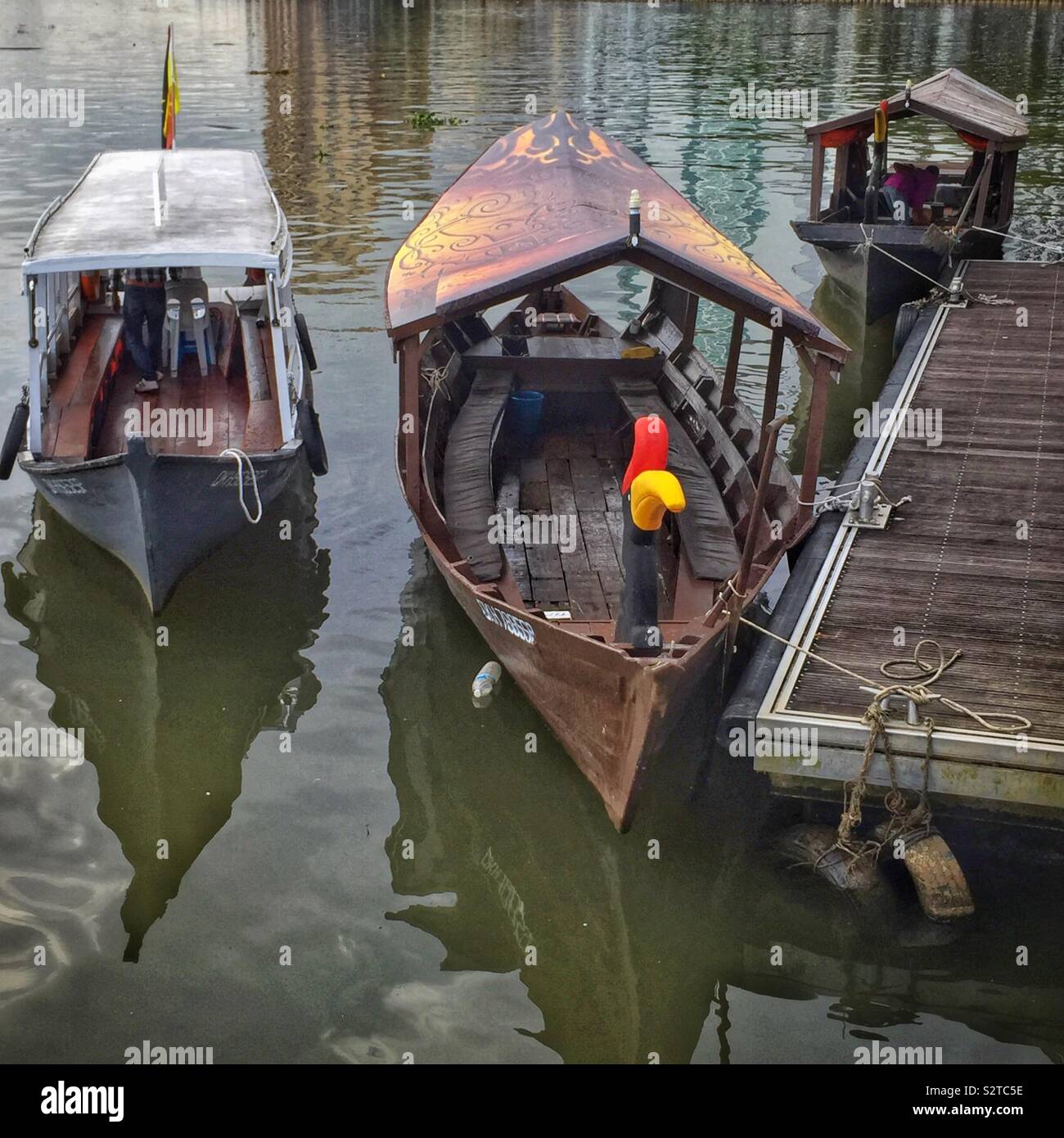 Traditional Malay river boats used for tourist cruises on the Sarawak River, Kuching, Sarawak, Malaysia; (front and left) Orang Ulu boats, (rear) Iban longboat - Smartphone Captured Stock Image