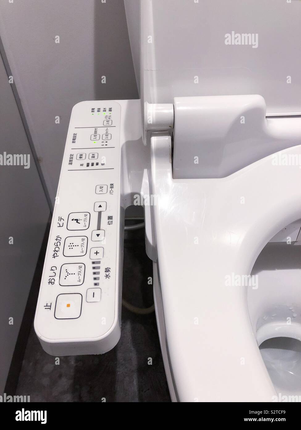 Control buttons on the side of a toilet seat in Japan. Stock Photo