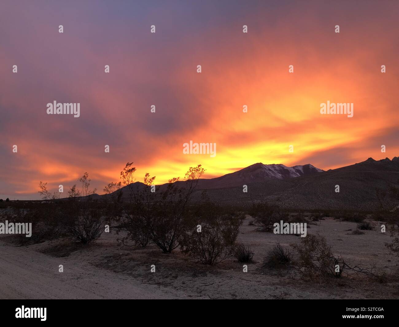 Beautiful flaming sunset over the Eastern Sierra mountains near Inyokern, California. Stock Photo