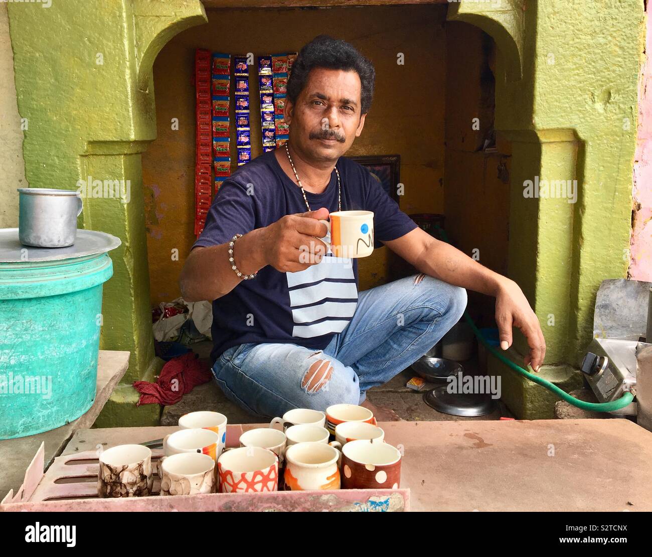 Indian man selling chai from his small shop in Varanasi, India Stock Photo