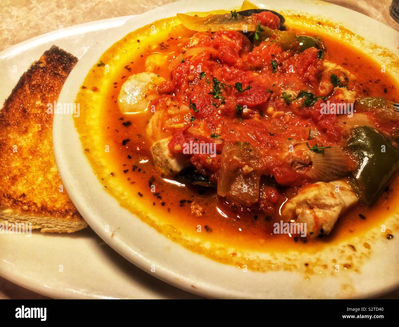 Famous tomato based cioppino seafood stew served at 42nd street oyster bar in Raleigh, North Carolina. - Smartphone Captured Stock Image