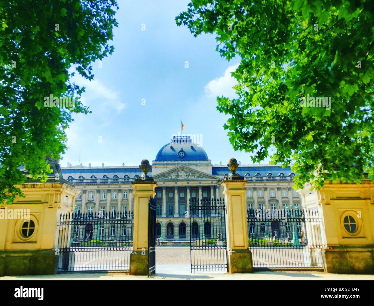 Palace of the Belgian king as seen through the gates of the park on the other side of the street, Brussels, Belgium - Smartphone Captured Stock Image