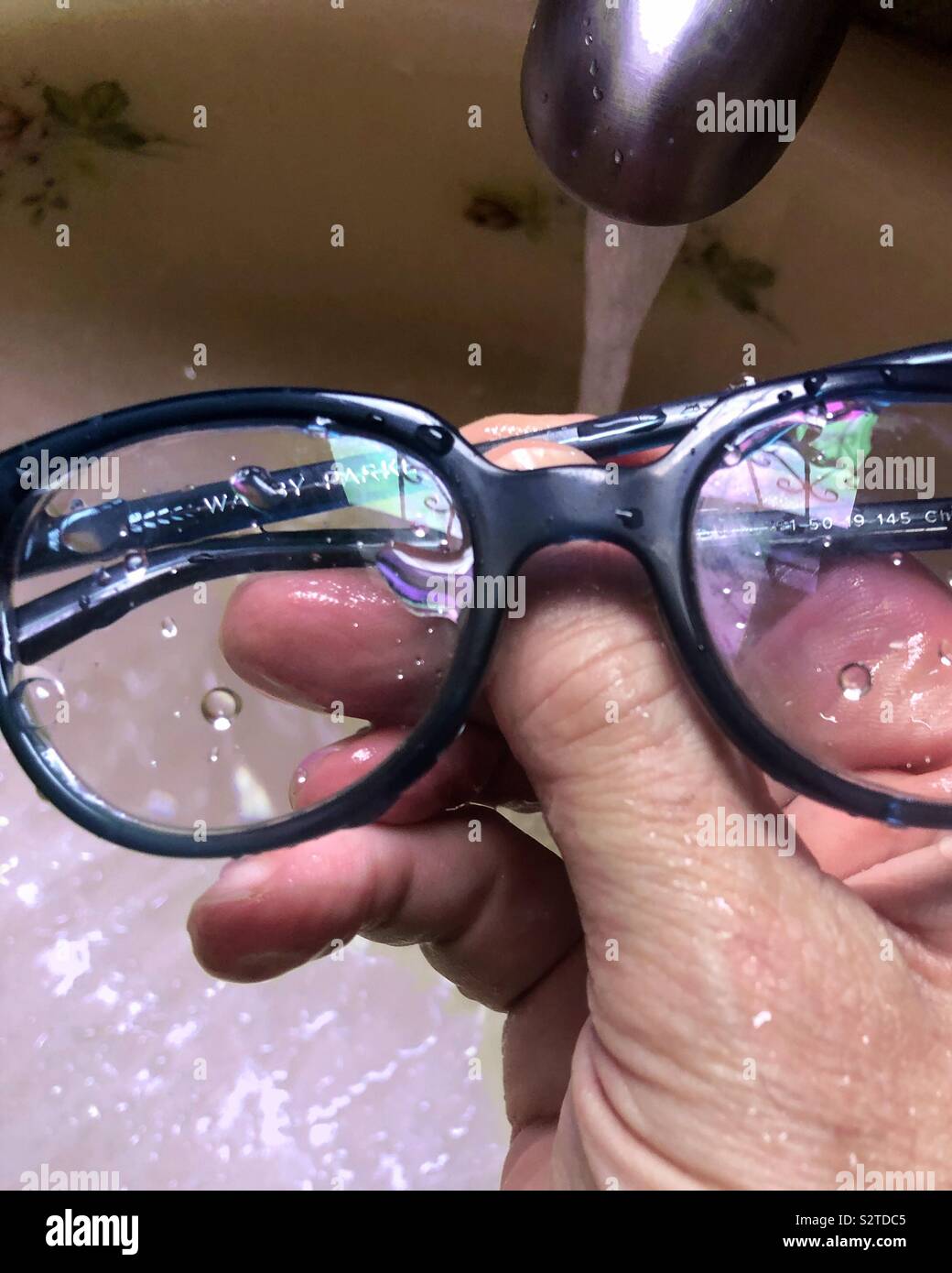 Cleaning my glasses. Stock Photo