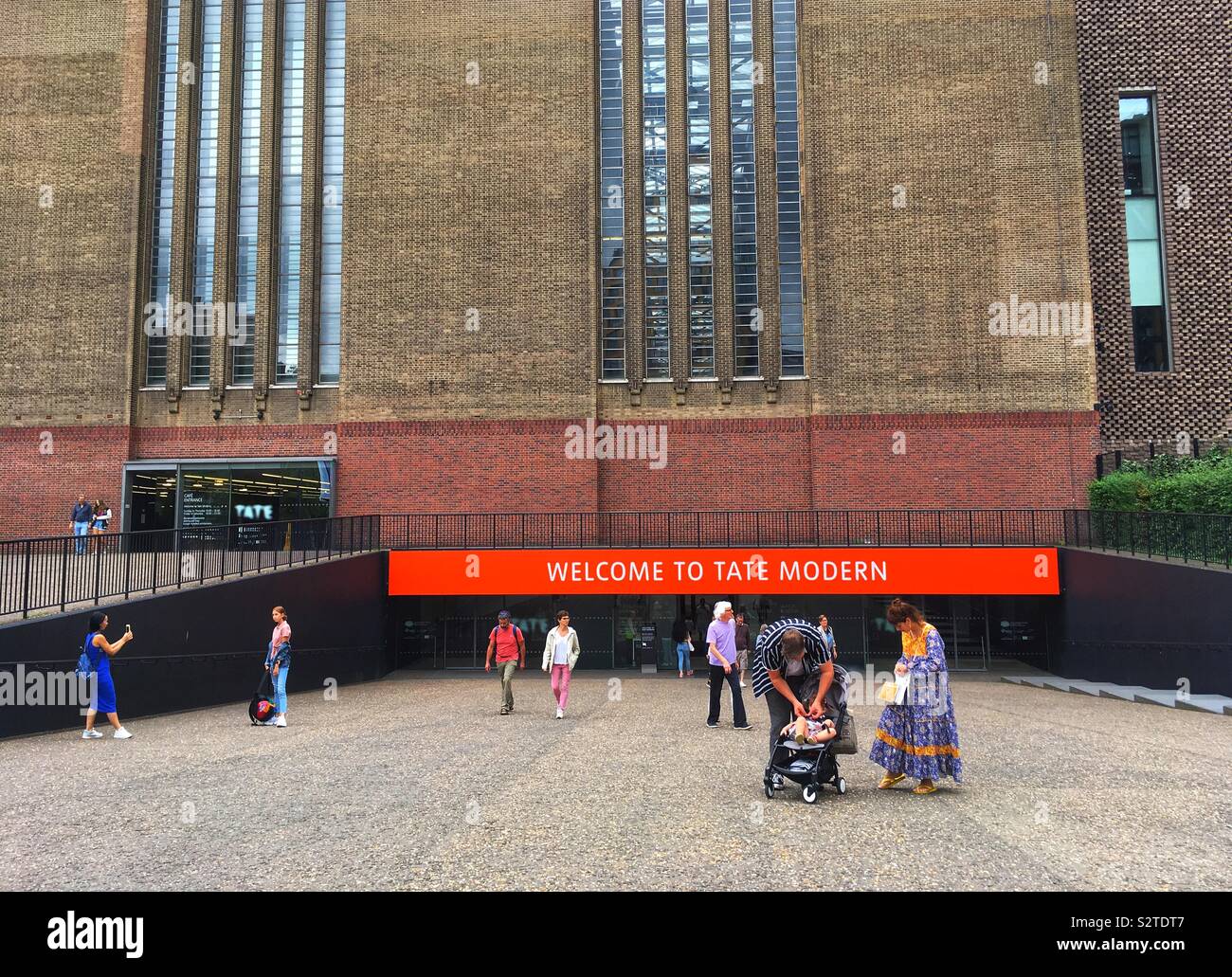 Visitors outside Tate Modern in London, United Kingdom in July 2019 - Smartphone Captured Stock Image