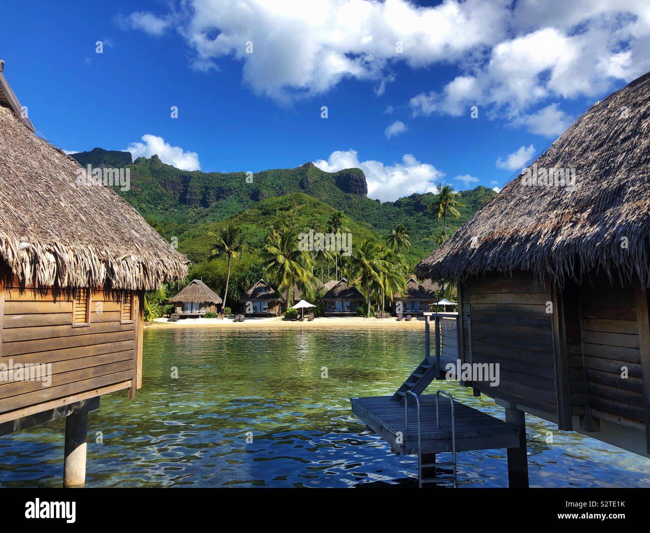 View between two overwater bungalows of a luxury beach resort on Moorea, French Polynesia as seen from the lagoon Stock Photo