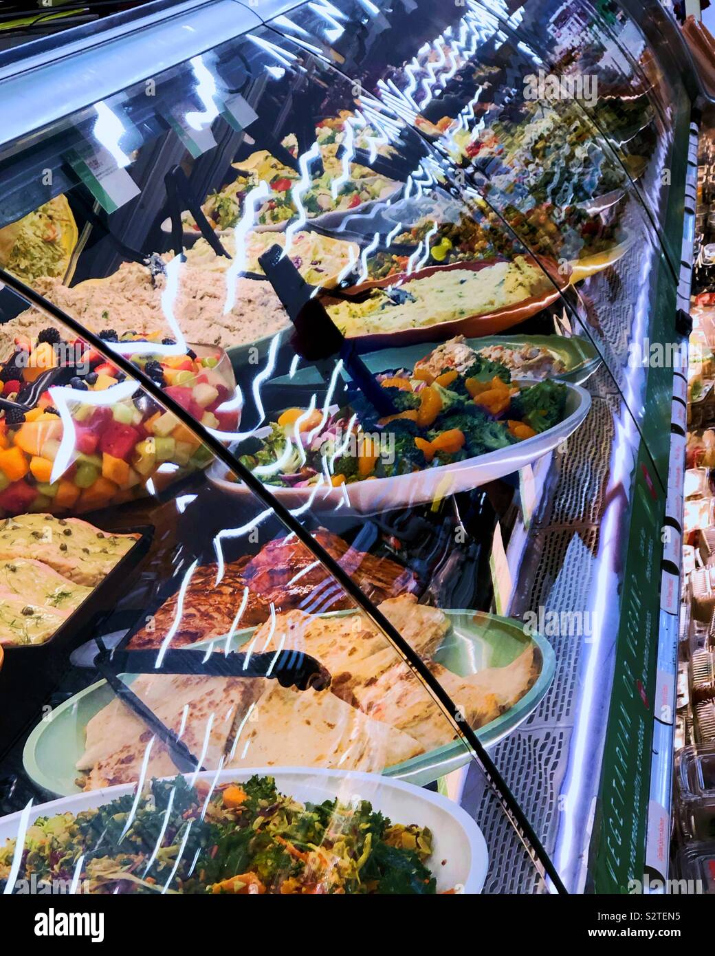 Looking at the takeout salads at the deli counter Stock Photo Alamy