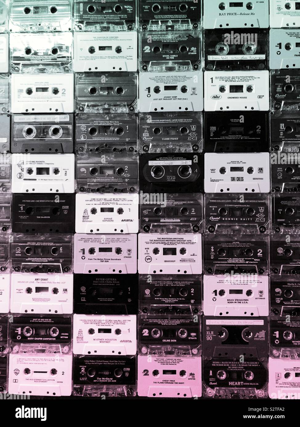 A wall covered in old cassette tapes in rows Stock Photo