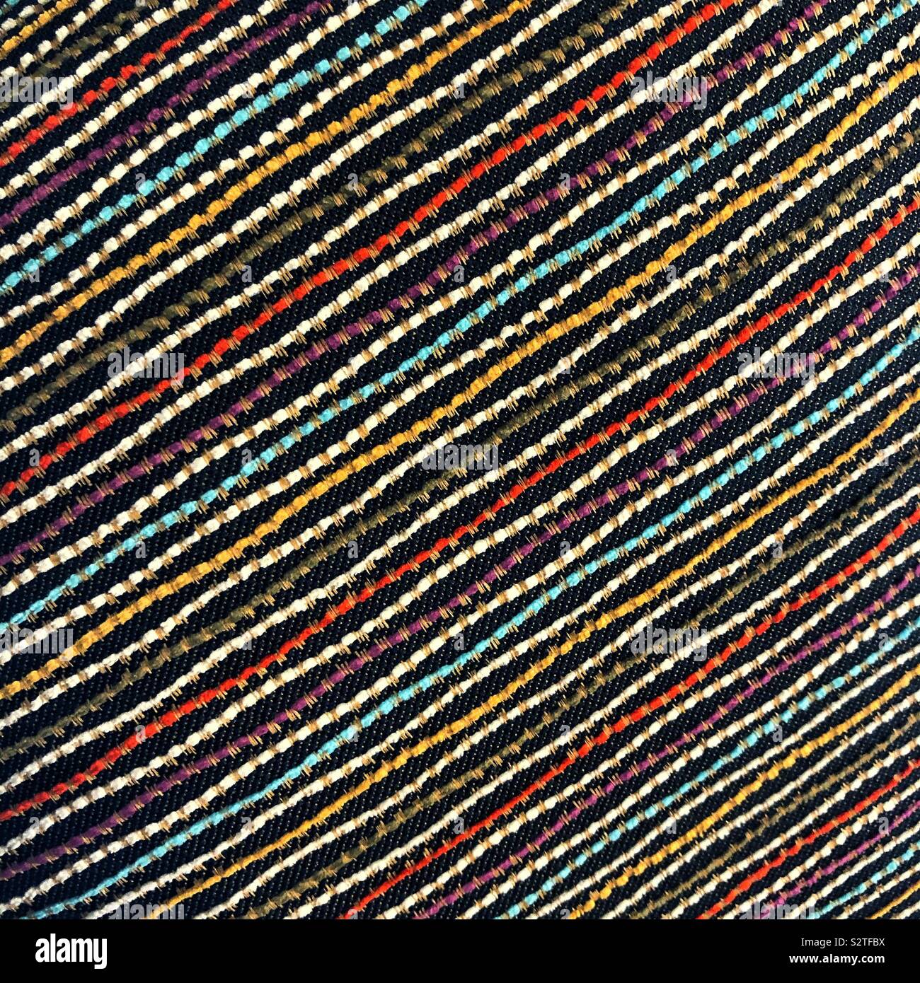 A closeup of a colorful woven pattern of diagonal lines - Smartphone Captured Stock Image
