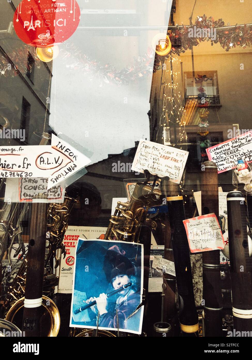 Paris street reflects in the music store window Stock Photo