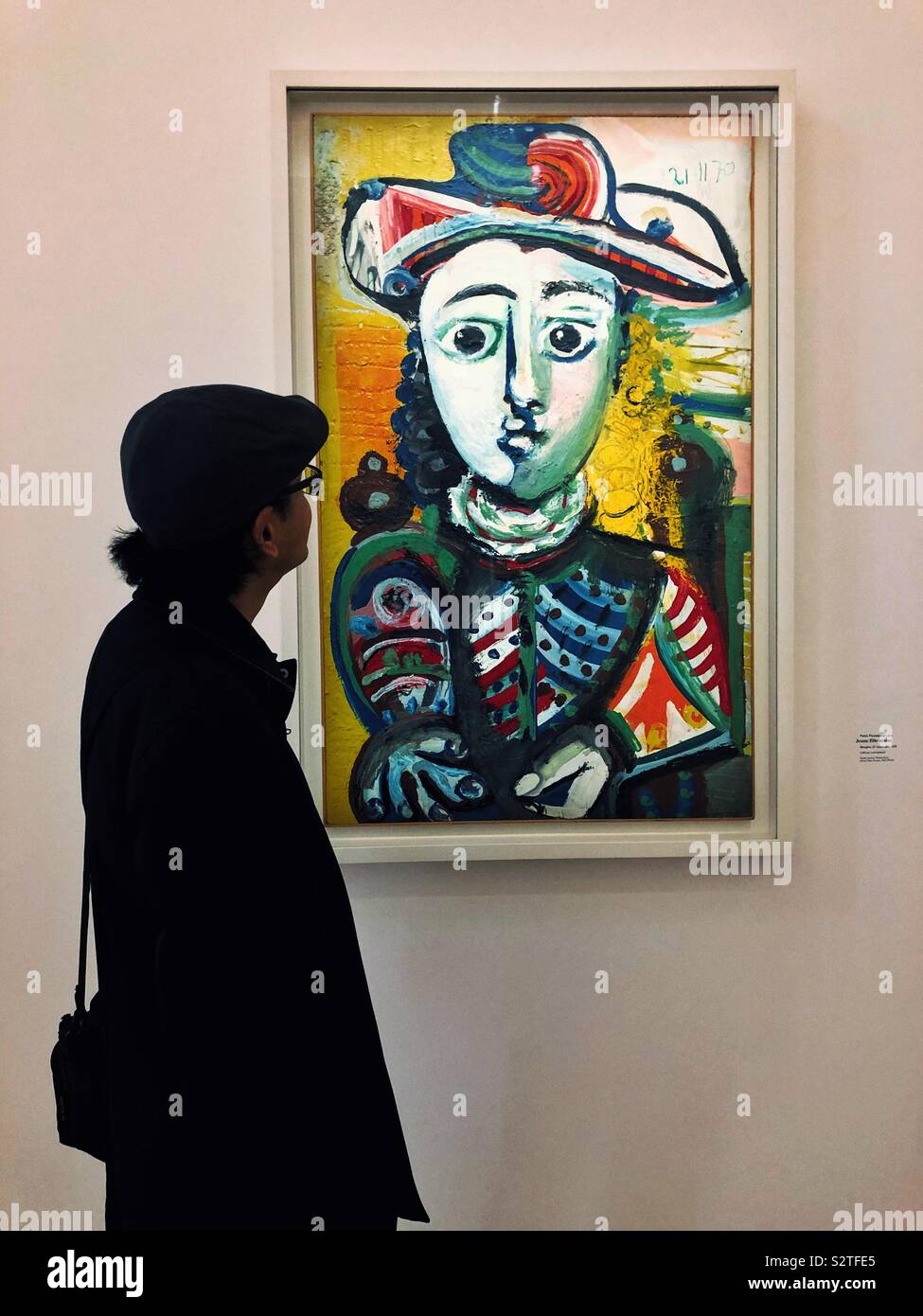 Tourist admires portrait by Pablo Picasso in Paris - Smartphone Captured Stock Image
