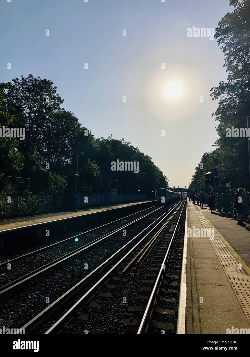 Sun on the morning of the hottest london July day25th July 2019 coming up over plumstead train station platform Stock Photo