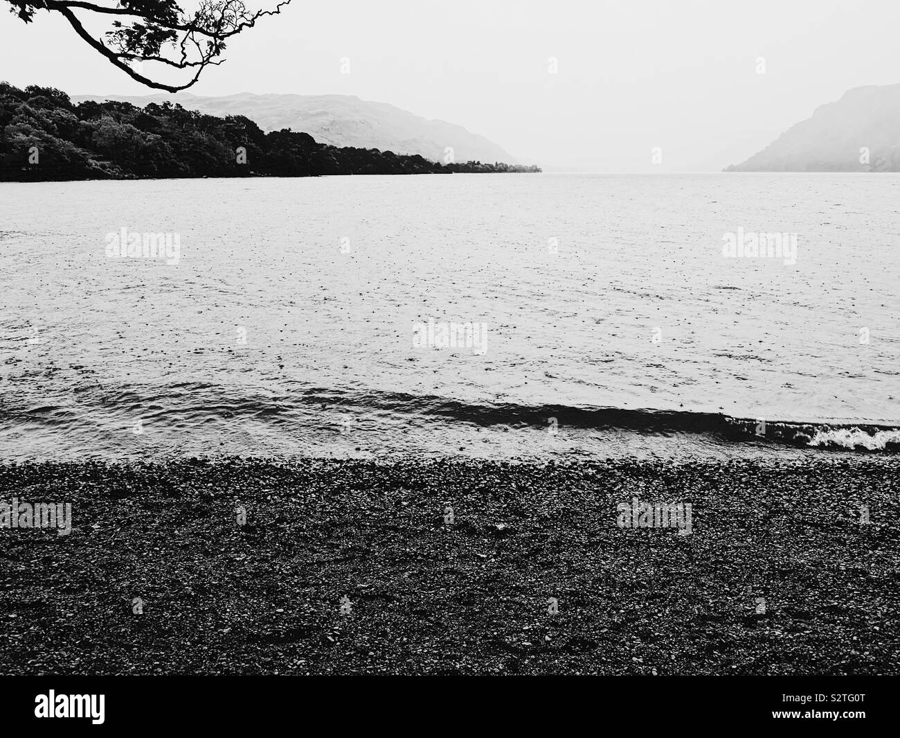 Black and white image of summer rain, Ullswater, Lake District, England - Smartphone Captured Stock Image