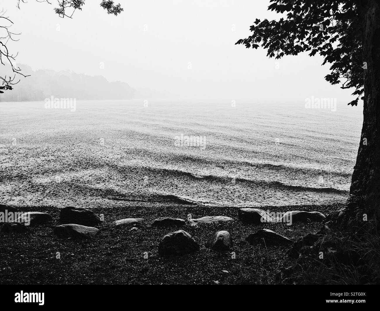 Black and white image of summer rain, Ullswater, Lake District, England - Smartphone Captured Stock Image