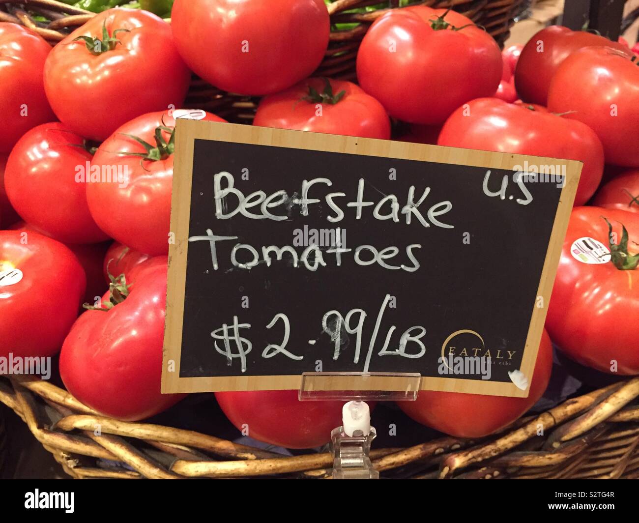 Beefstake tomatoes for sale in the produce aisle of the grocery store, USA Stock Photo
