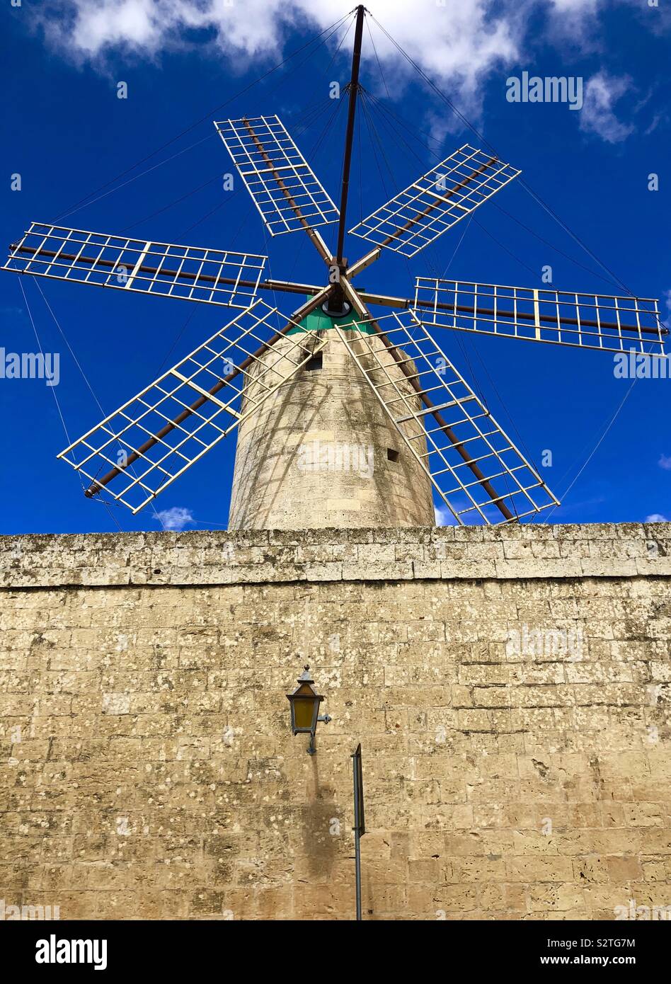 Old windmill against a blue sky Stock Photo