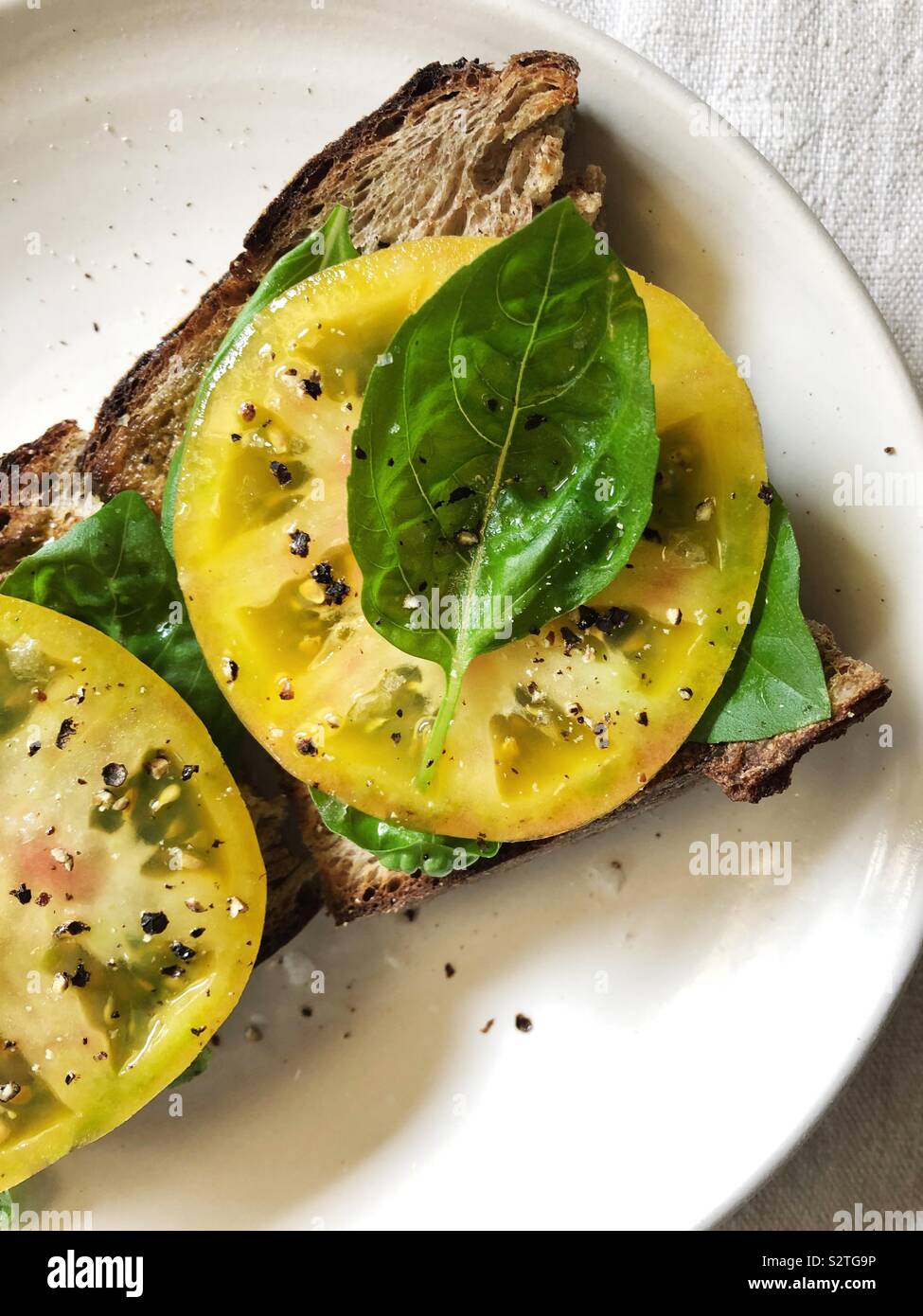 Heirloom tomatoes with basil on toast - Smartphone Captured Stock Image