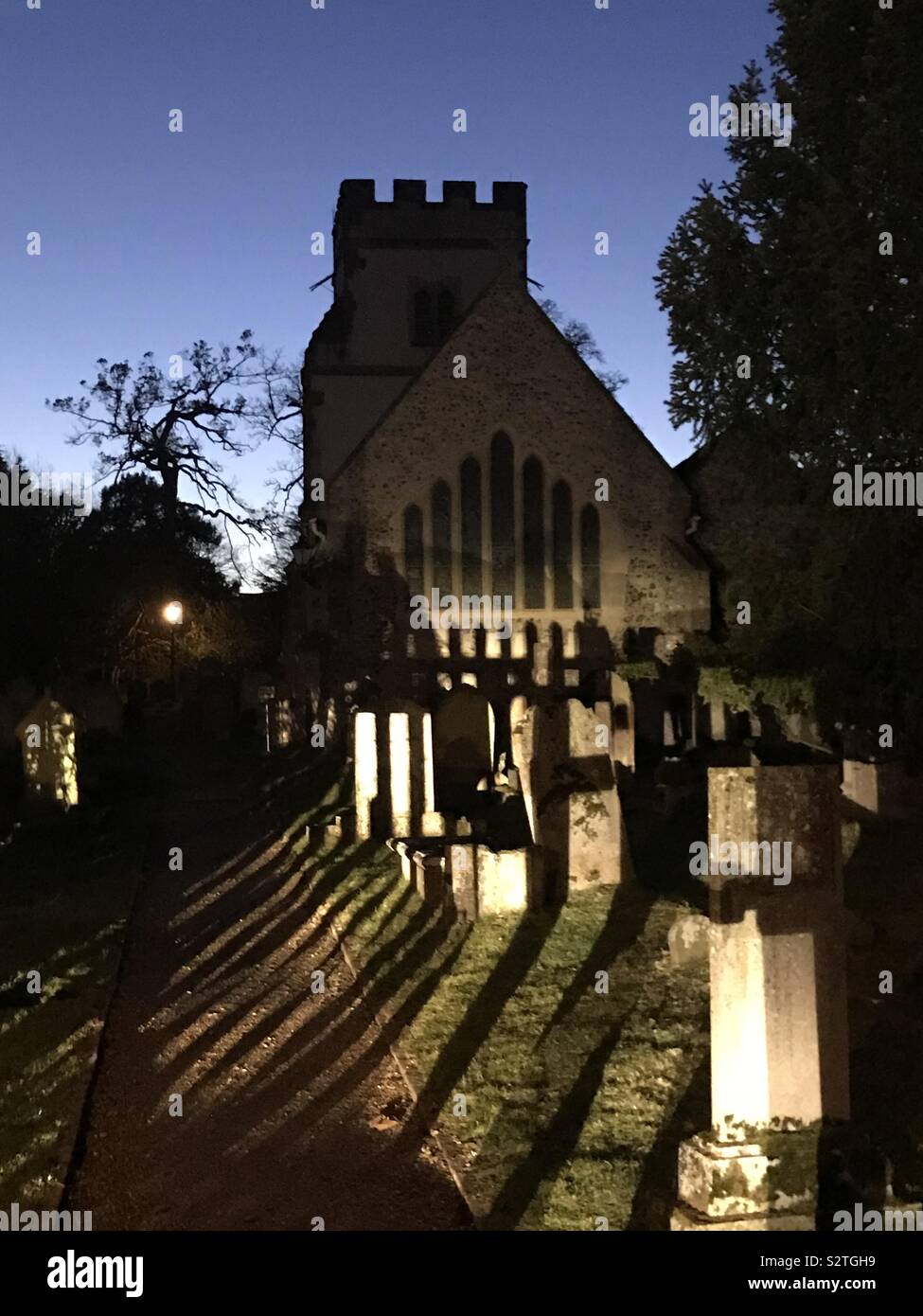 Long shadows in a churchyard at sunset Stock Photo - Alamy