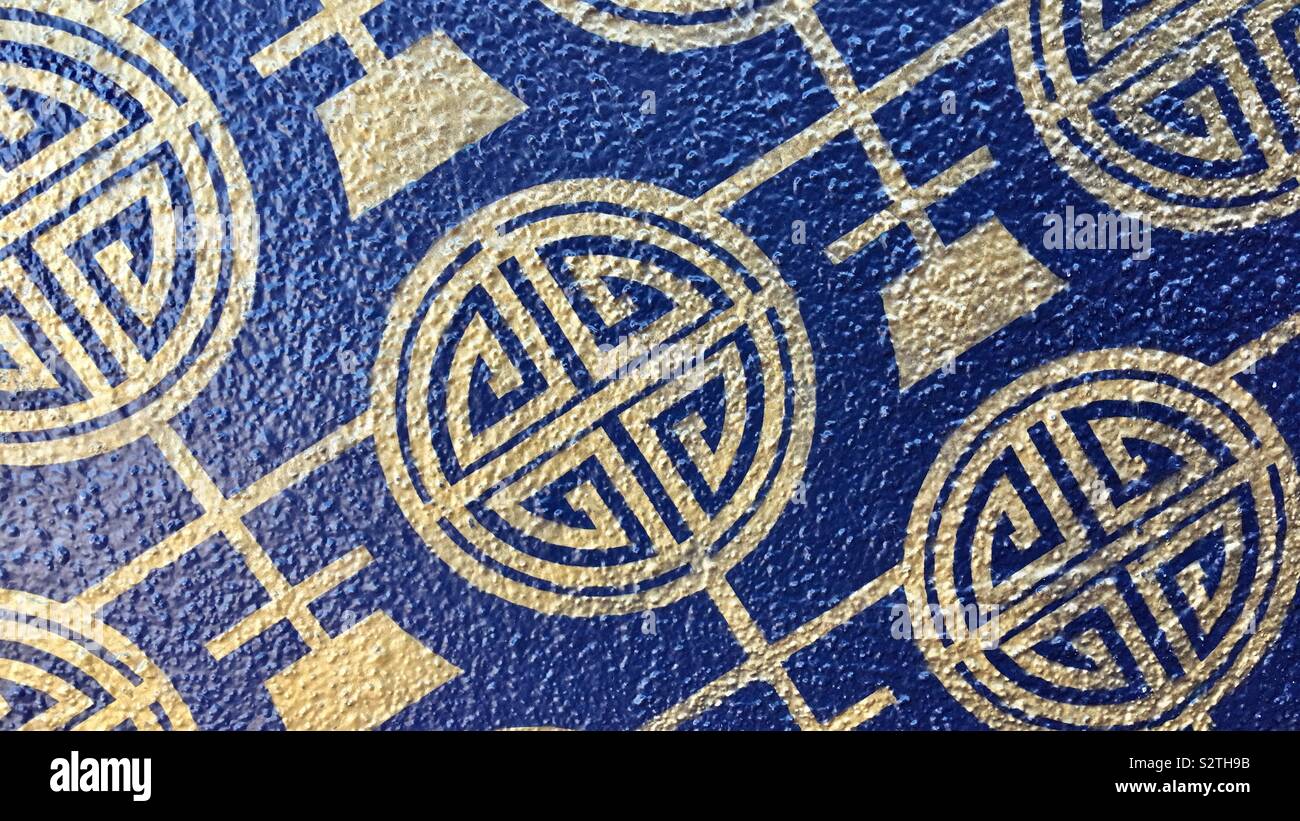 LOS ANGELES, CA, JUL 2019: gold pattern on blue background, side of building in Chinatown - Smartphone Captured Stock Image