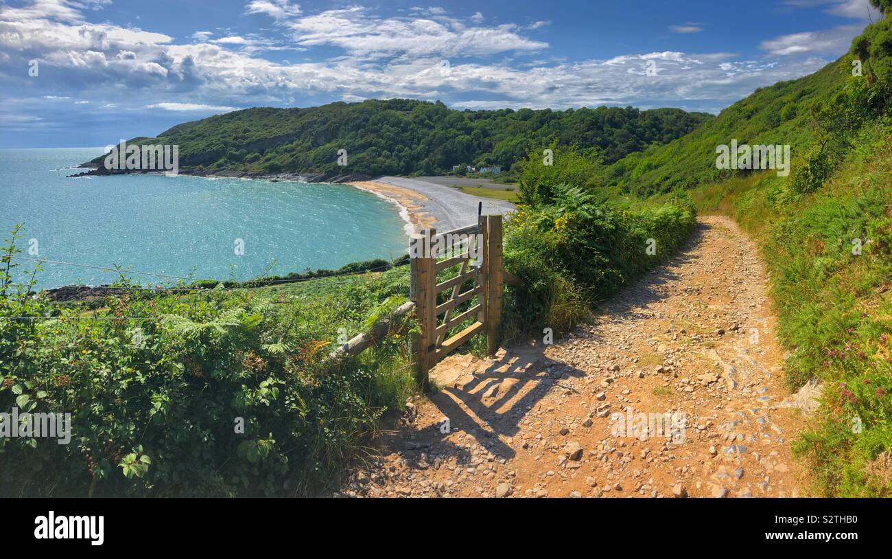 Wales coastal path heading towards Pwll Du beach, Gower, South West Wales, high tide, July. Stock Photo