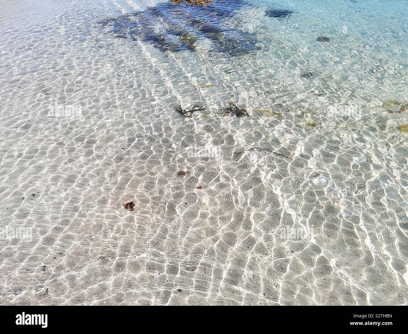 Ripples and patterns in clear transparent sunlit ocean - Smartphone Captured Stock Image