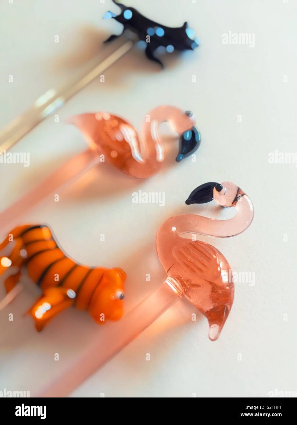 Kitsch animal likeness Glass stir sticks on a white background Stock