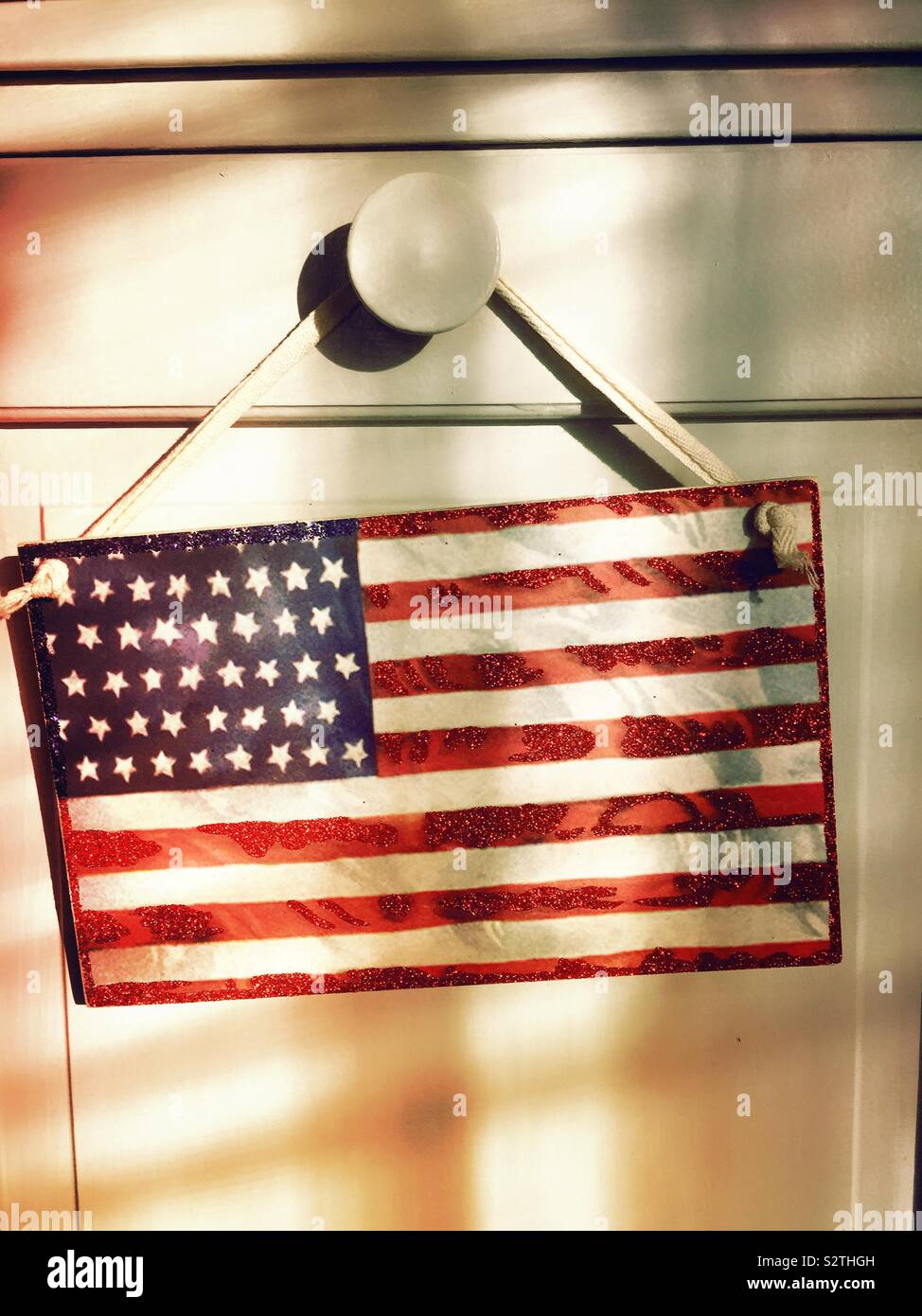 Decorative Wooden American Flag Hanging From The Doorknob In A