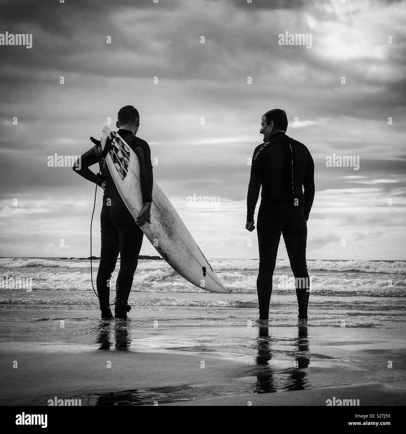 Surfers, Gwithian Towans Beach, Cornwall. Stock Photo