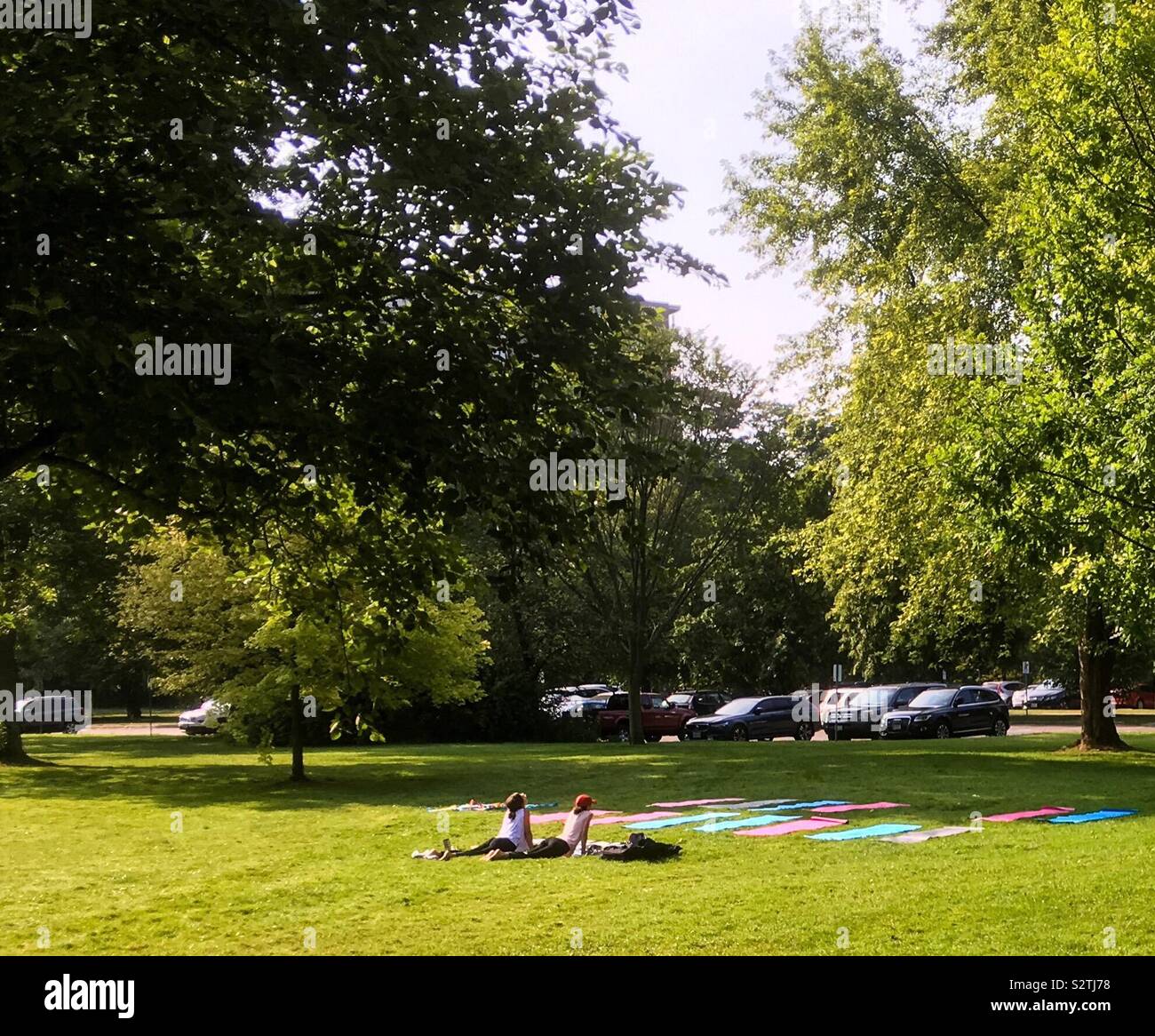 Yoga in a busy park - Smartphone Captured Stock Image