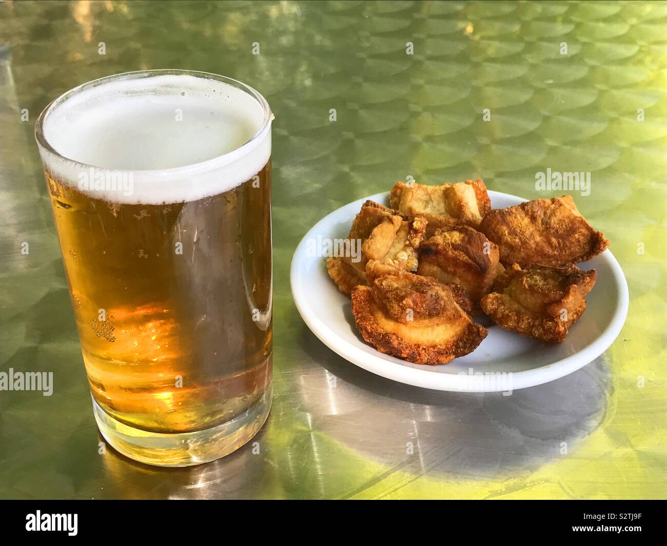 Glass of beer and torreznos as tapa. Spain - Smartphone Captured Stock Image