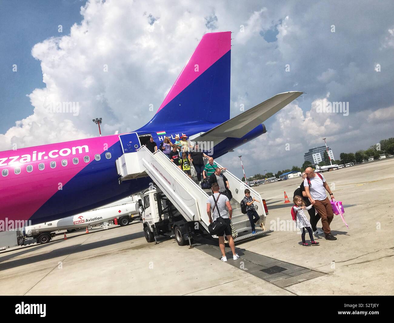 Passengers disembark from a Wizzair Airbus A320 on arrival in a sunny Warsaw Poland Stock Photo